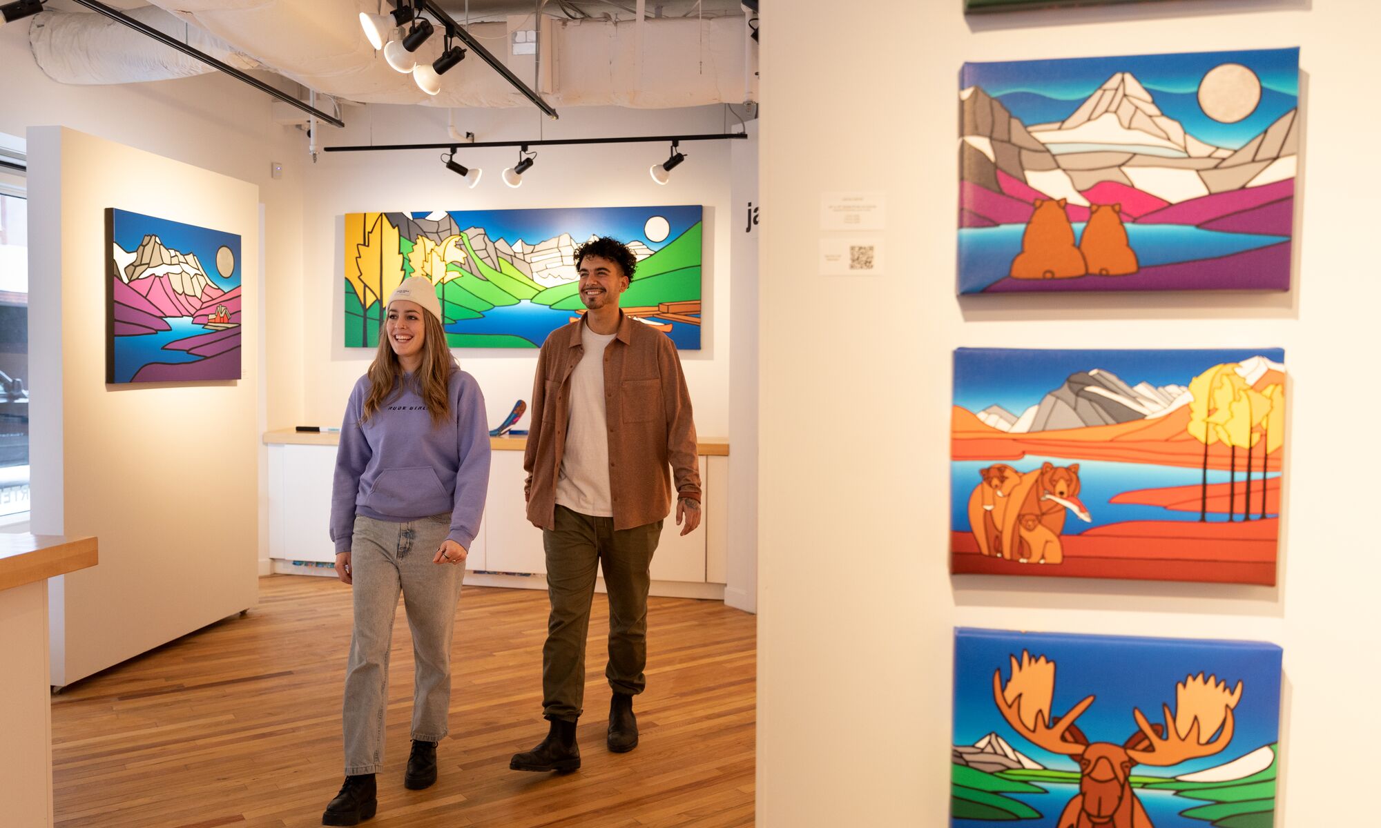 Two people walk through the Carter Ryan Gallery in Banff.